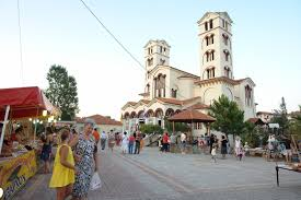 The church square of Neoi Poroi with market stalls in the evening