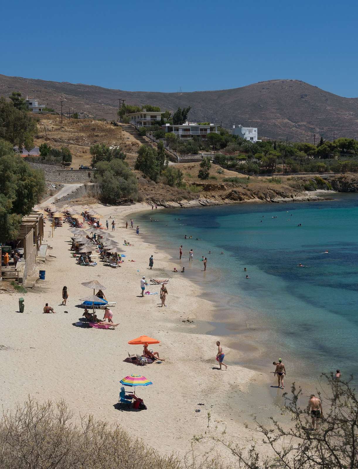 Wide golden sandy beach with clear turquoise water