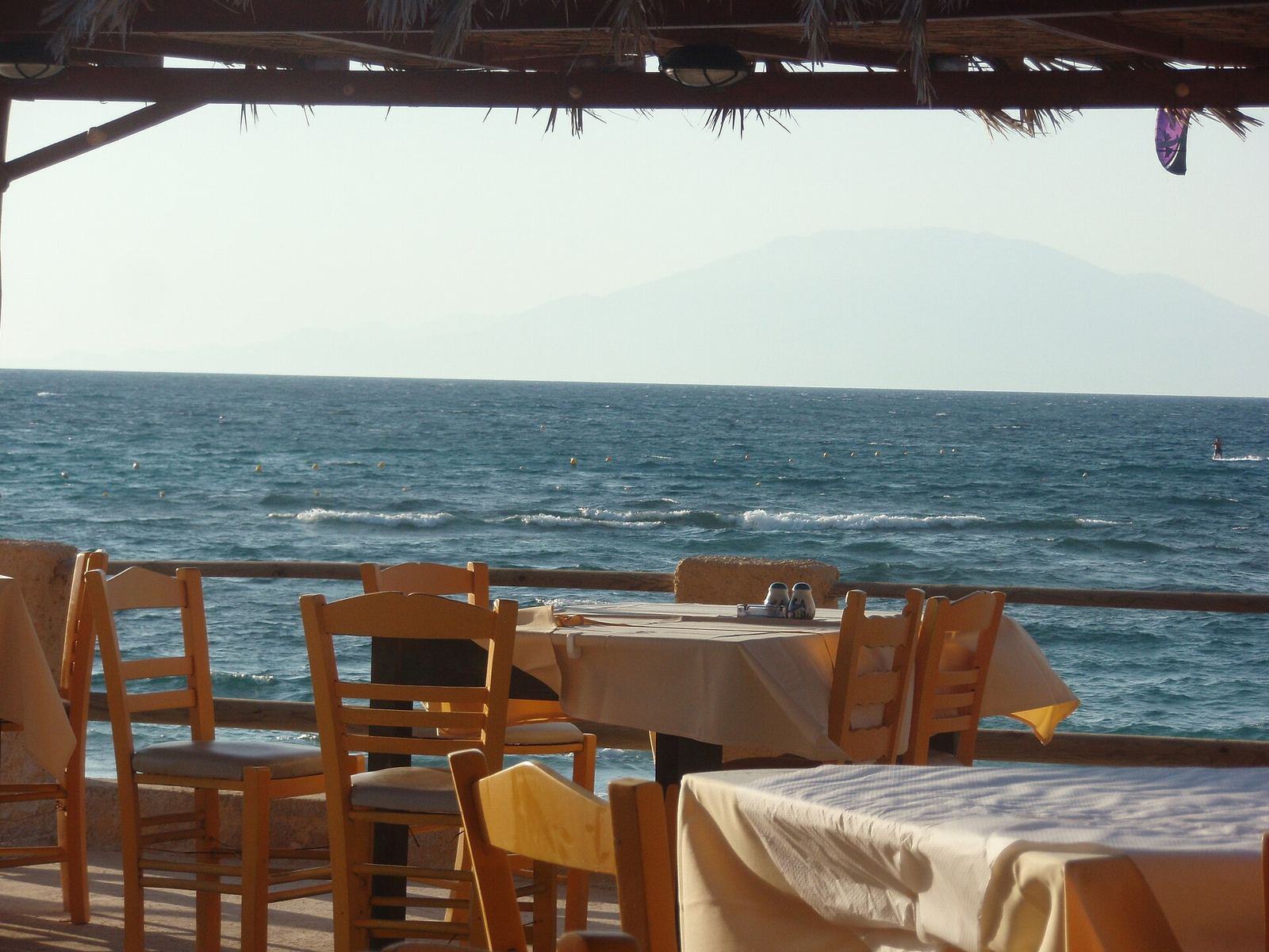 Greek seaside taverna under tamarisk trees
